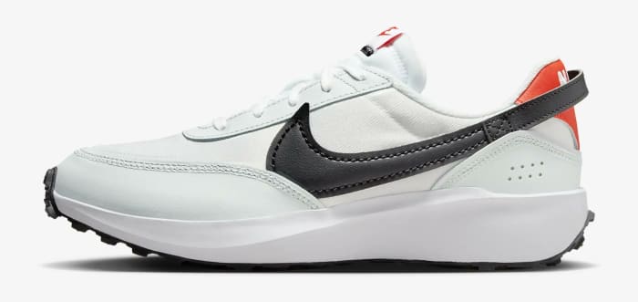 Side view of a white and black Nike running shoe.